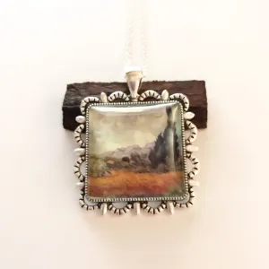 Oil painting on a pendant/autumn grass under a cloudy sky